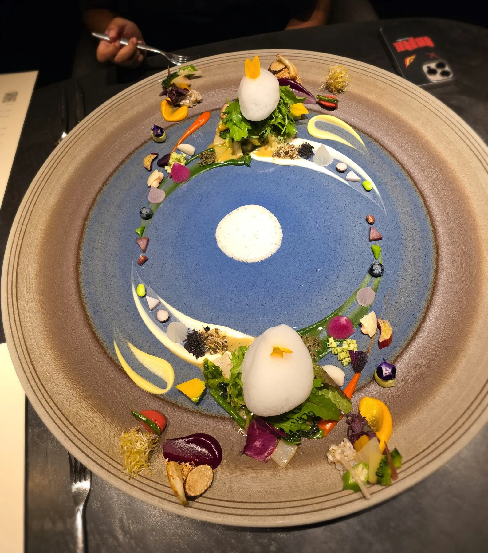 Large blue plate arranged with dozens of vegetables