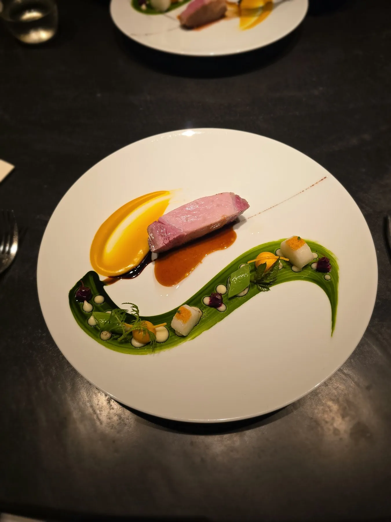 Pork with a green sauce swoosh