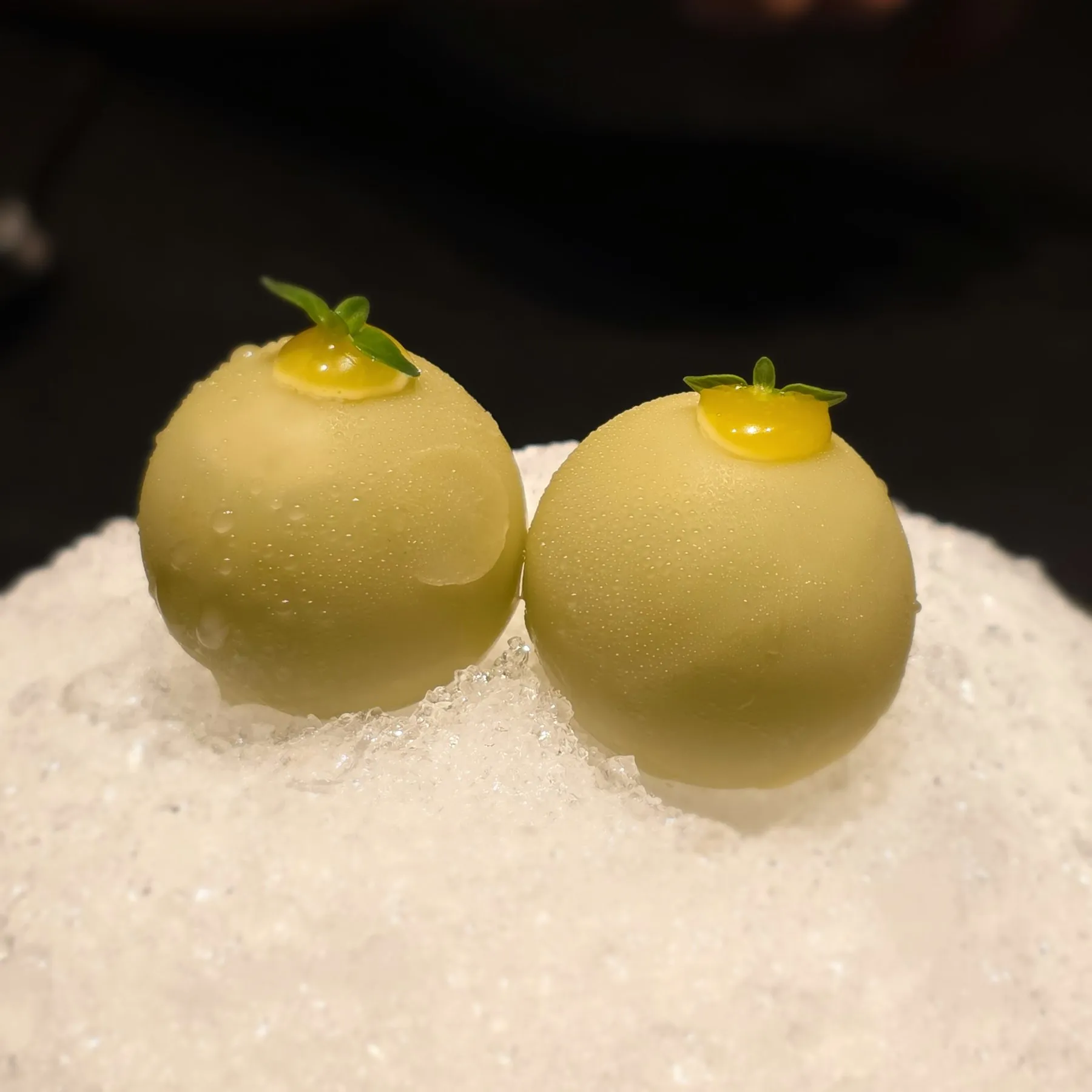 Two green spheres on shaved ice