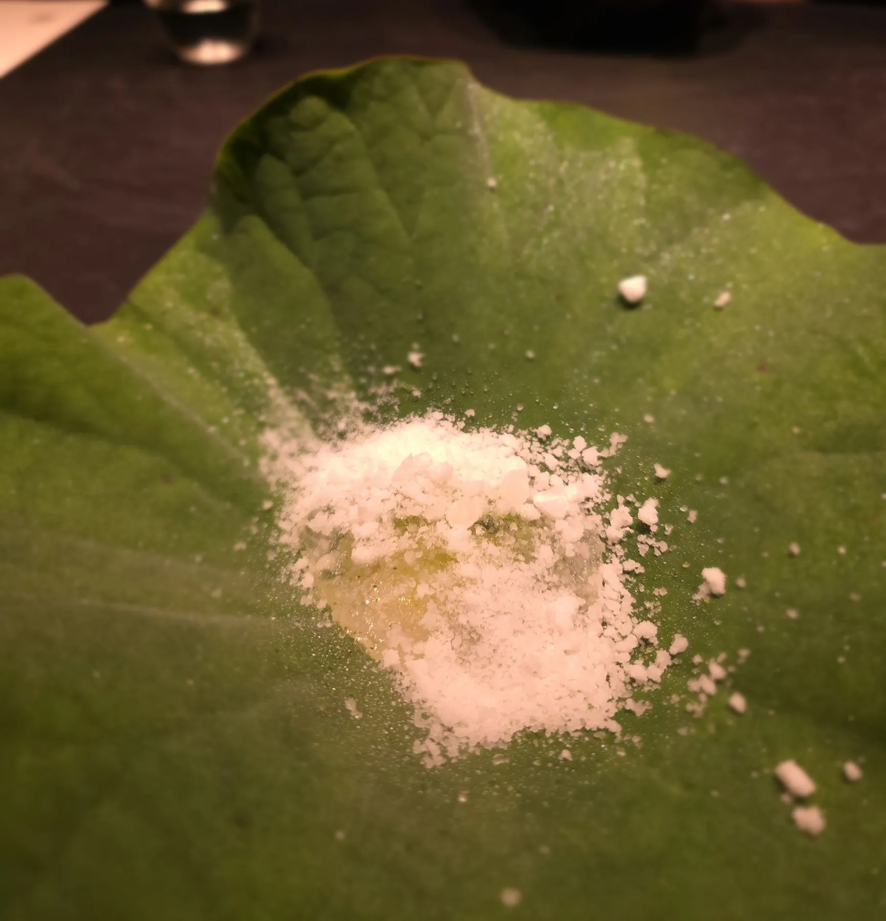 Pink granita scattered on a lotus leaf