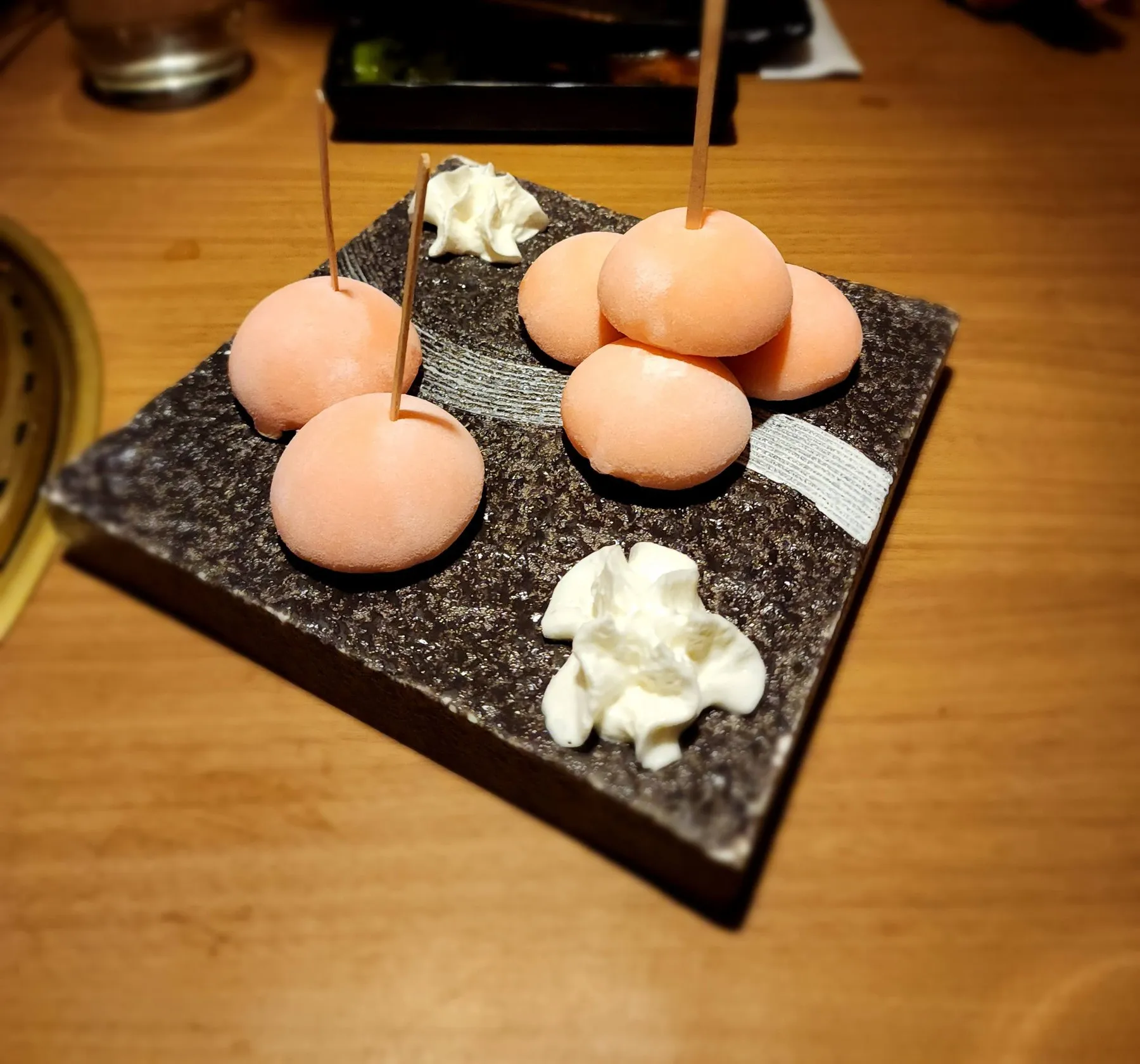 Pink mochi on a stone slab