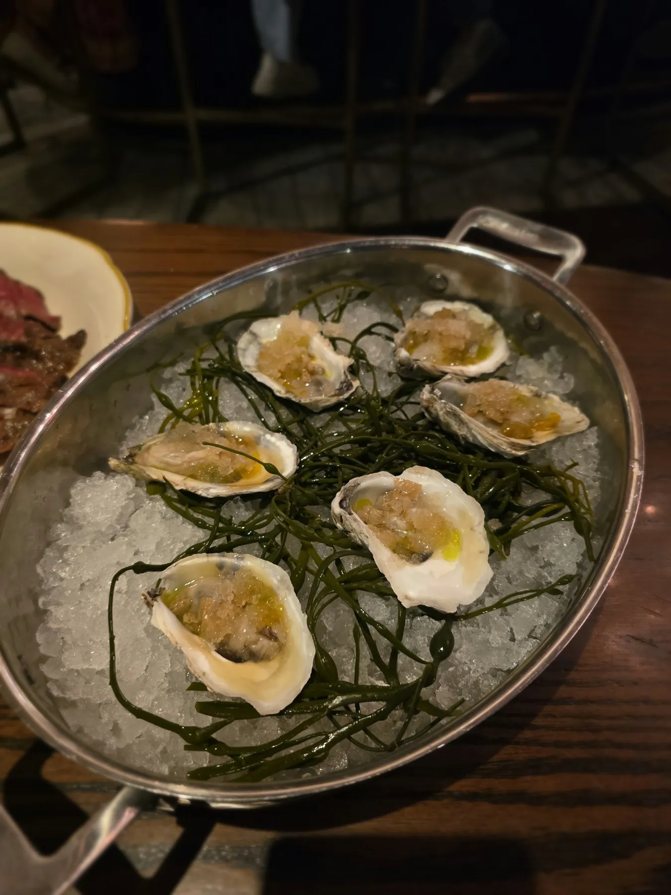 Raw oysters on ice with seaweed