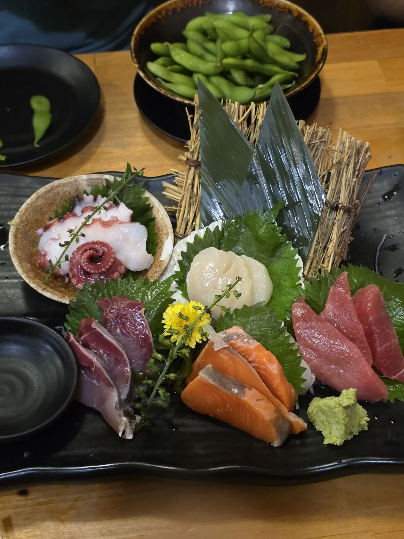 Sashimi platter with octopus, tuna, salmon, and edamame