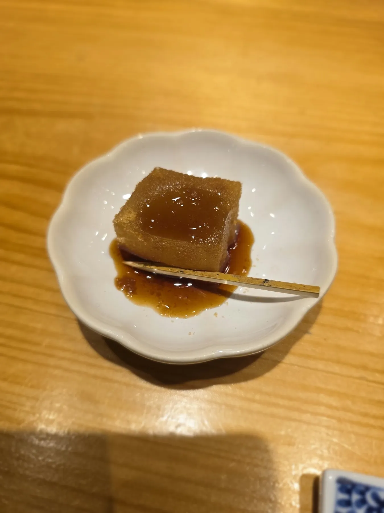 Cube of warabi mochi with black sugar syrup