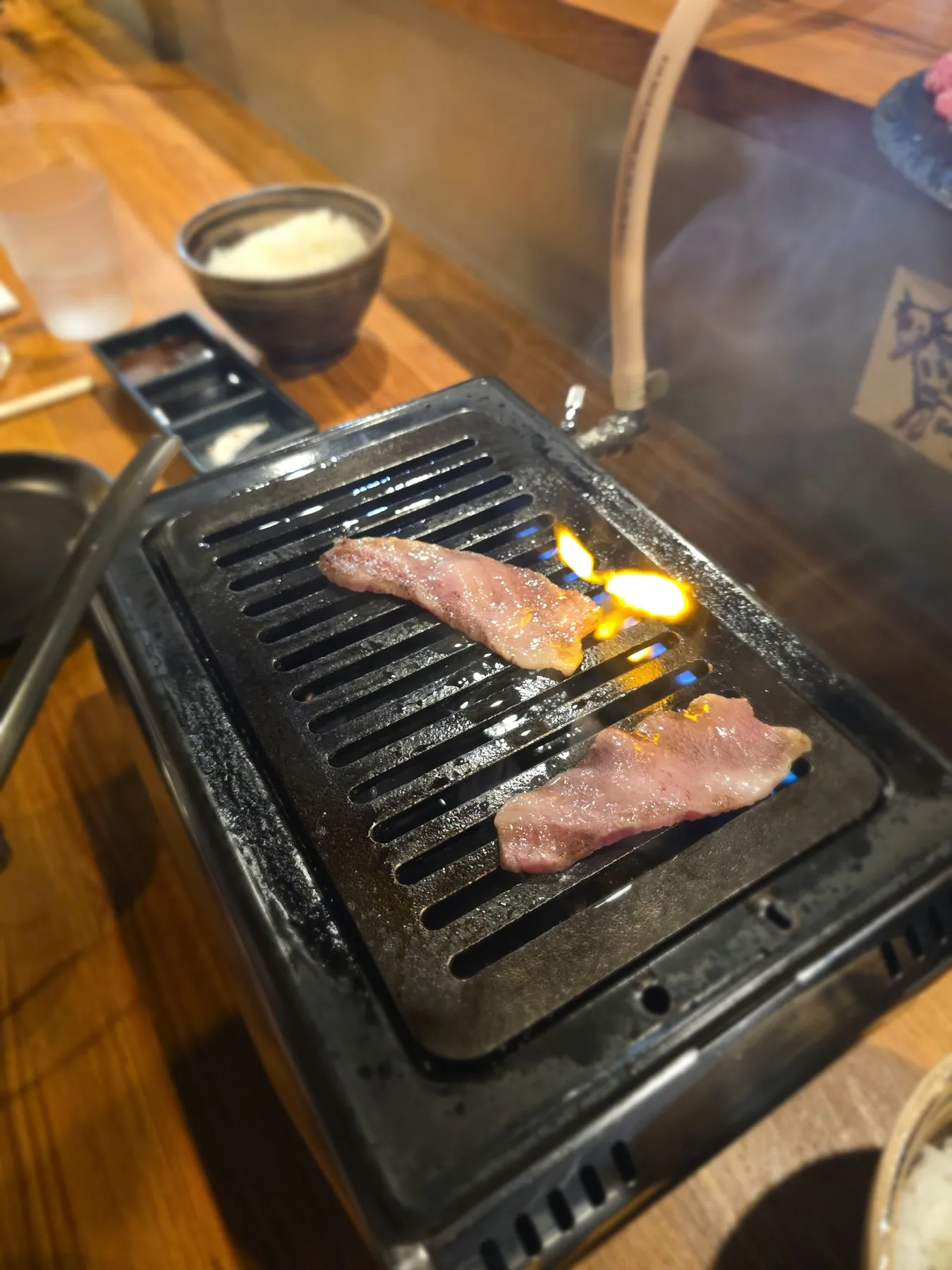 Slices of beef tongue on a small grill