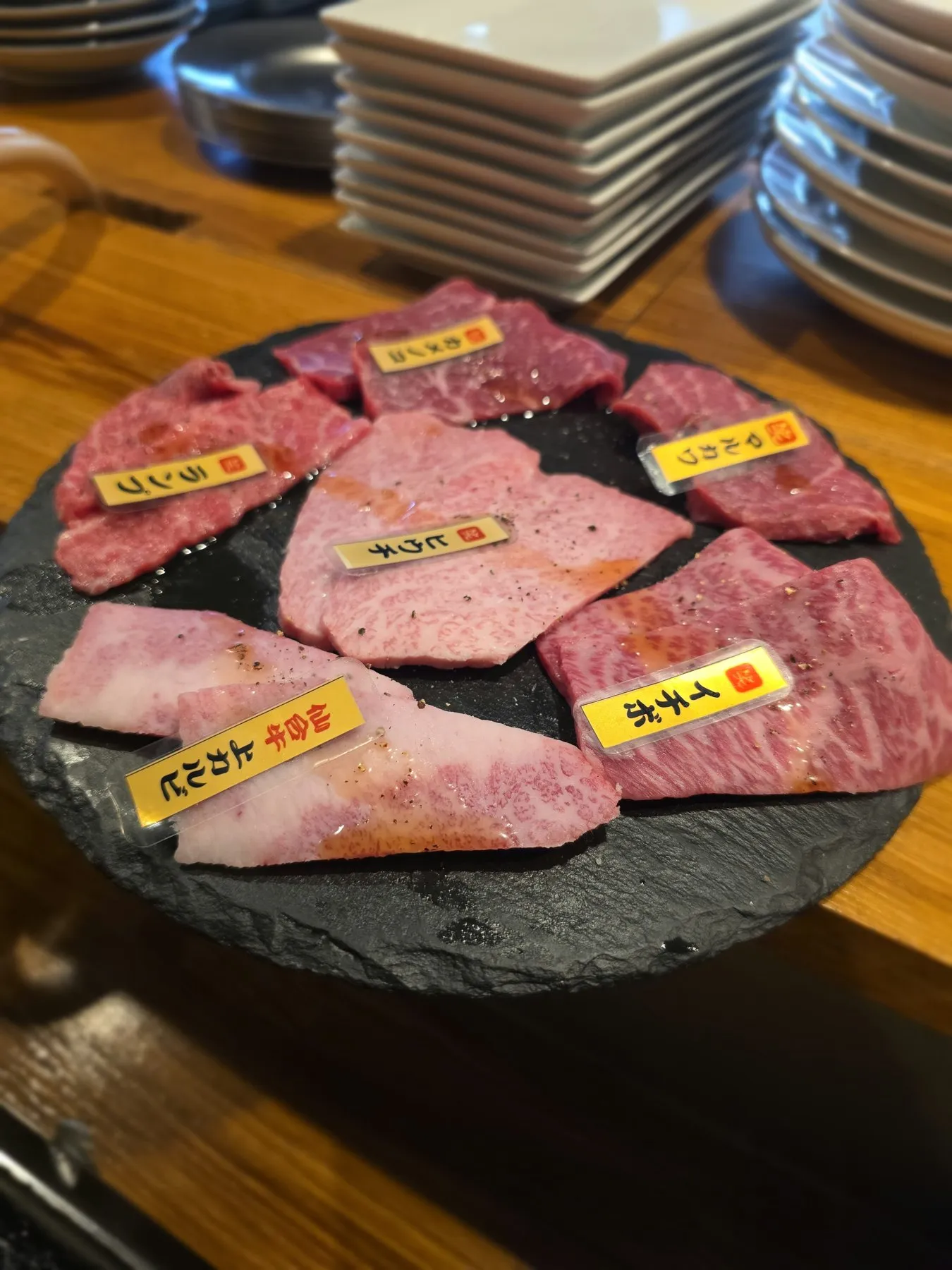 Labeled cuts of wagyu on a slate board
