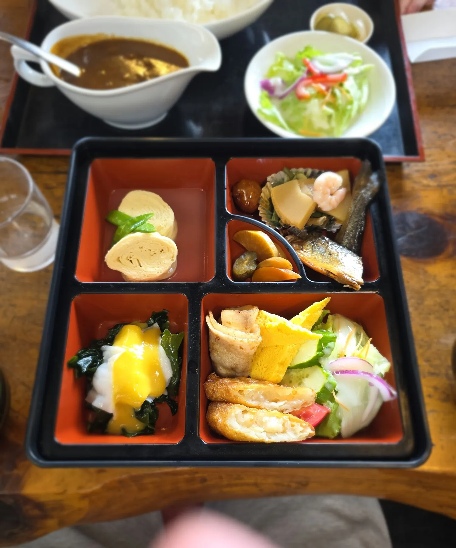 Bento box with tamago, fish, and pickles