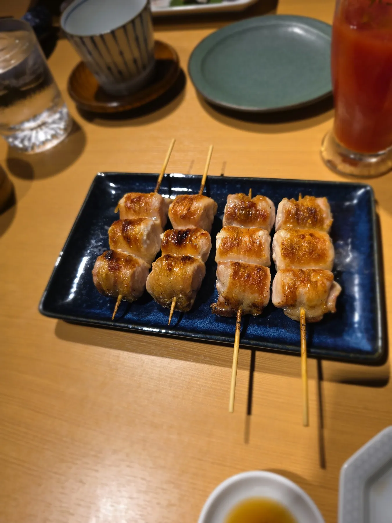Yakitori skewers on a blue plate