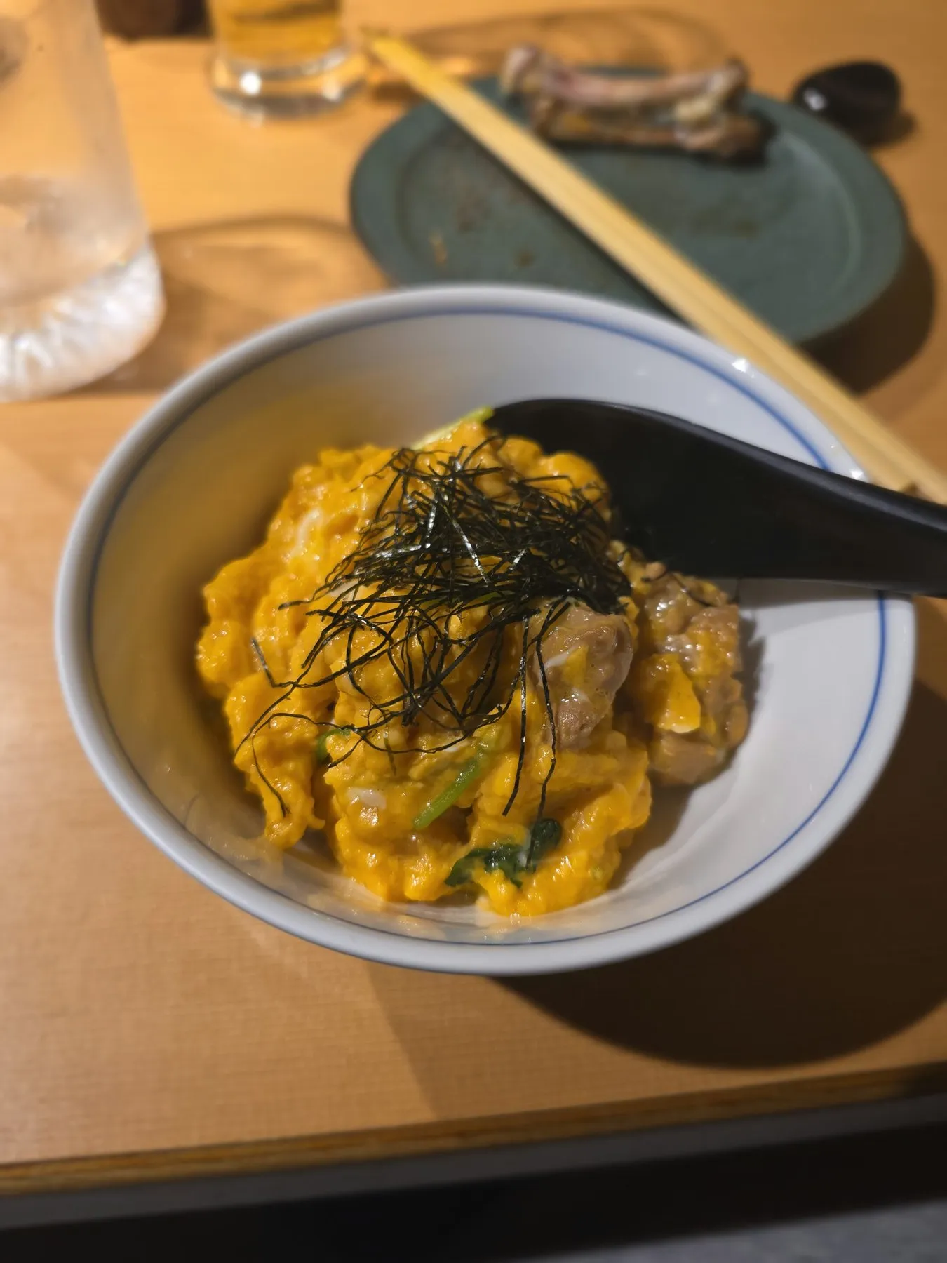 Bowl of oyakodon topped with nori