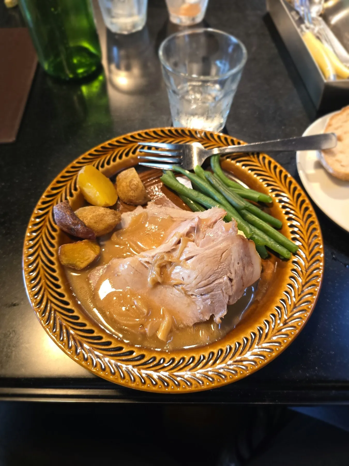 Plate of roast pork with potatoes and green beans