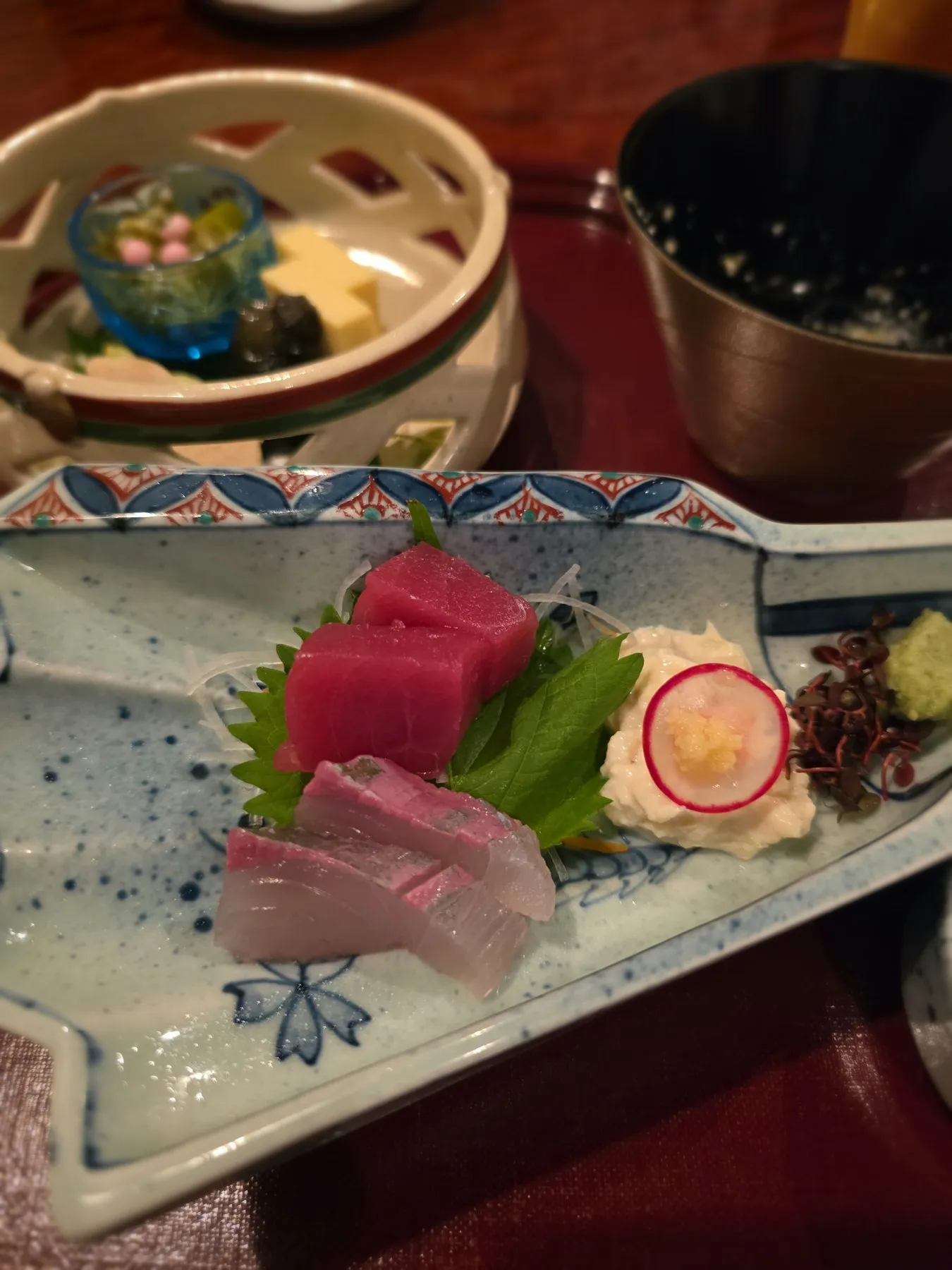 Tuna and yellowtail sashimi on a patterned plate