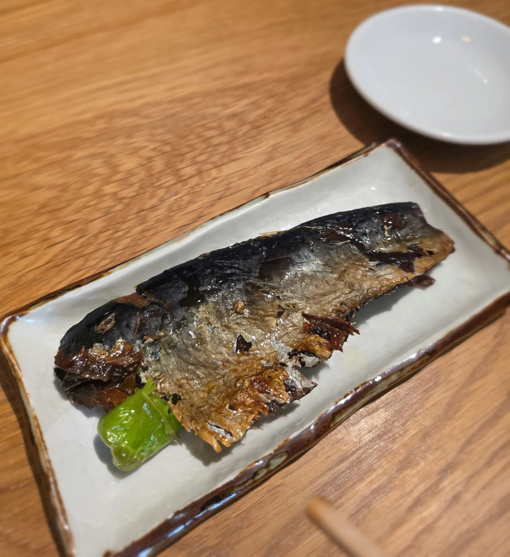 Whole grilled mackerel on a long plate