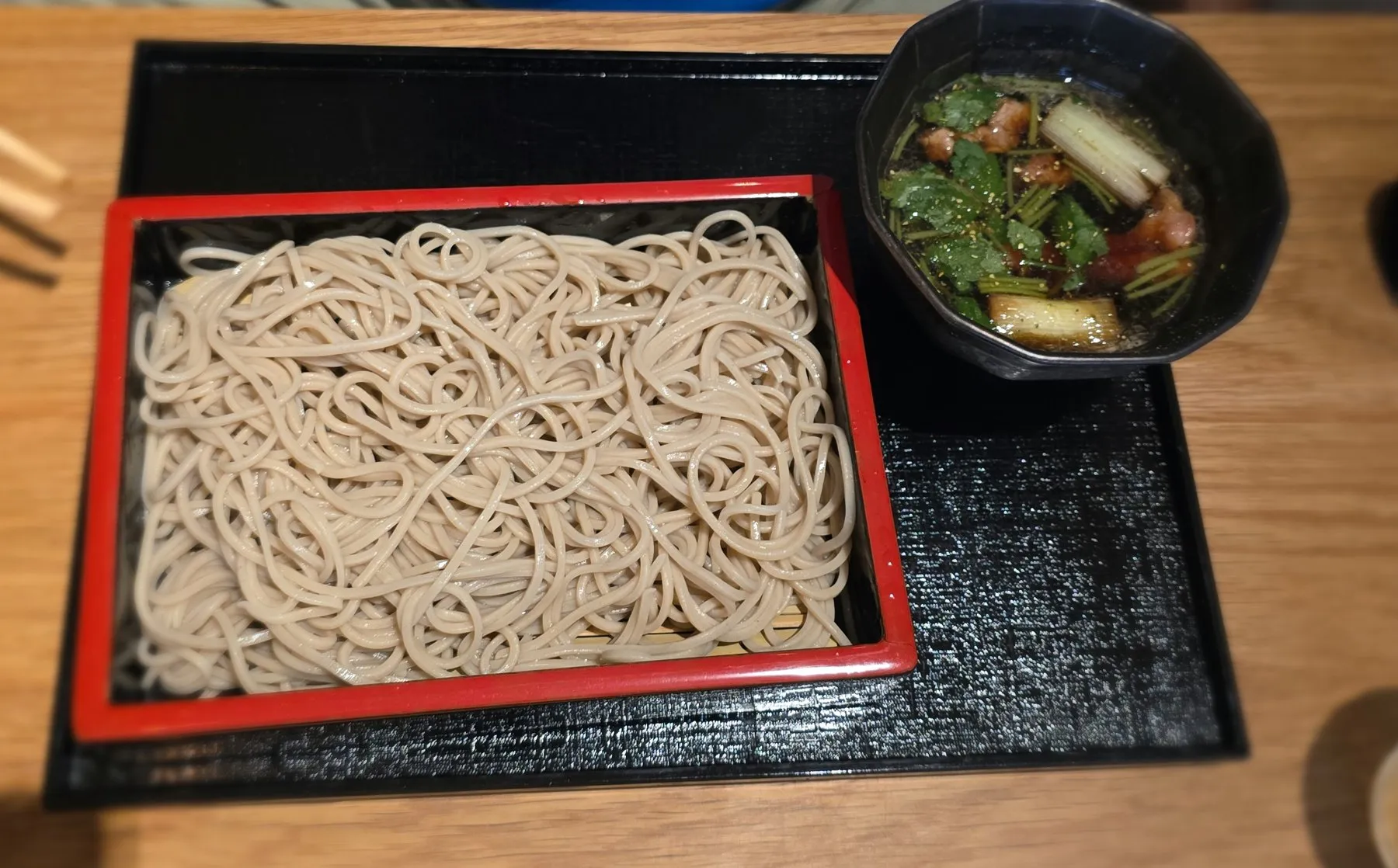 Tray of cold soba noodles with dipping sauce