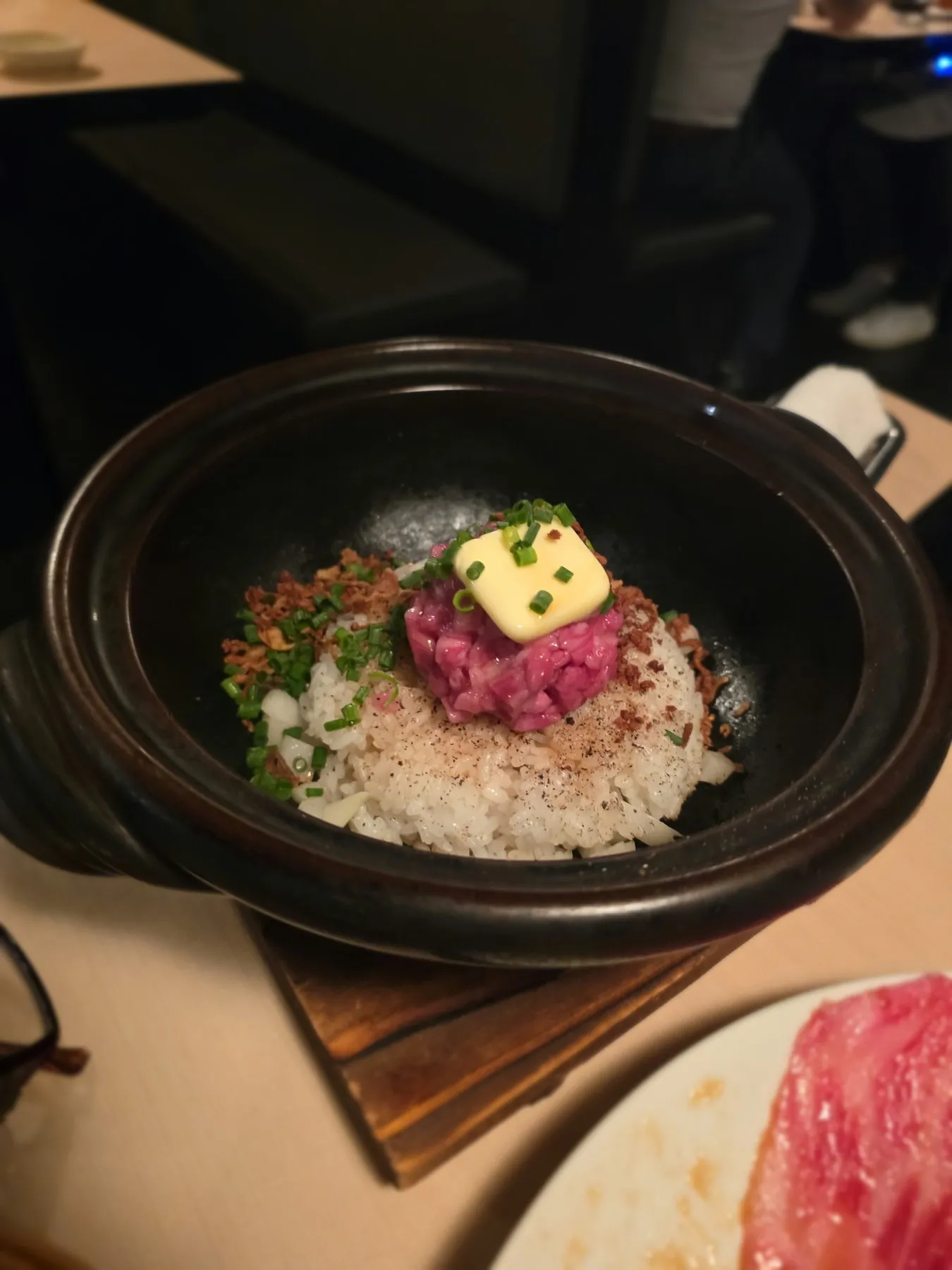 Clay pot of rice topped with wagyu tartare and butter