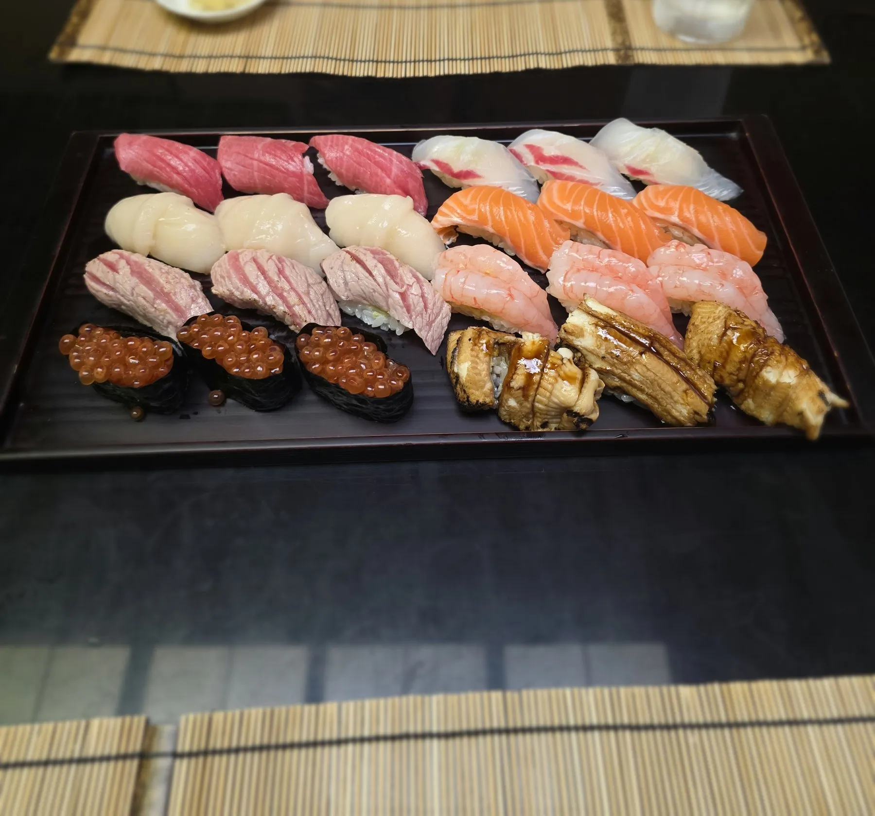 Full sushi platter on a black tray