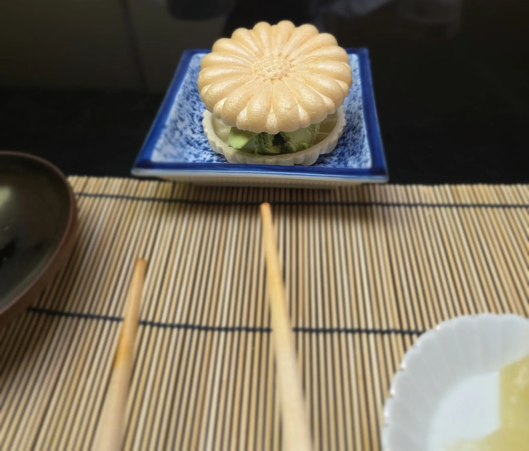 Chrysanthemum-shaped wagashi on a blue plate