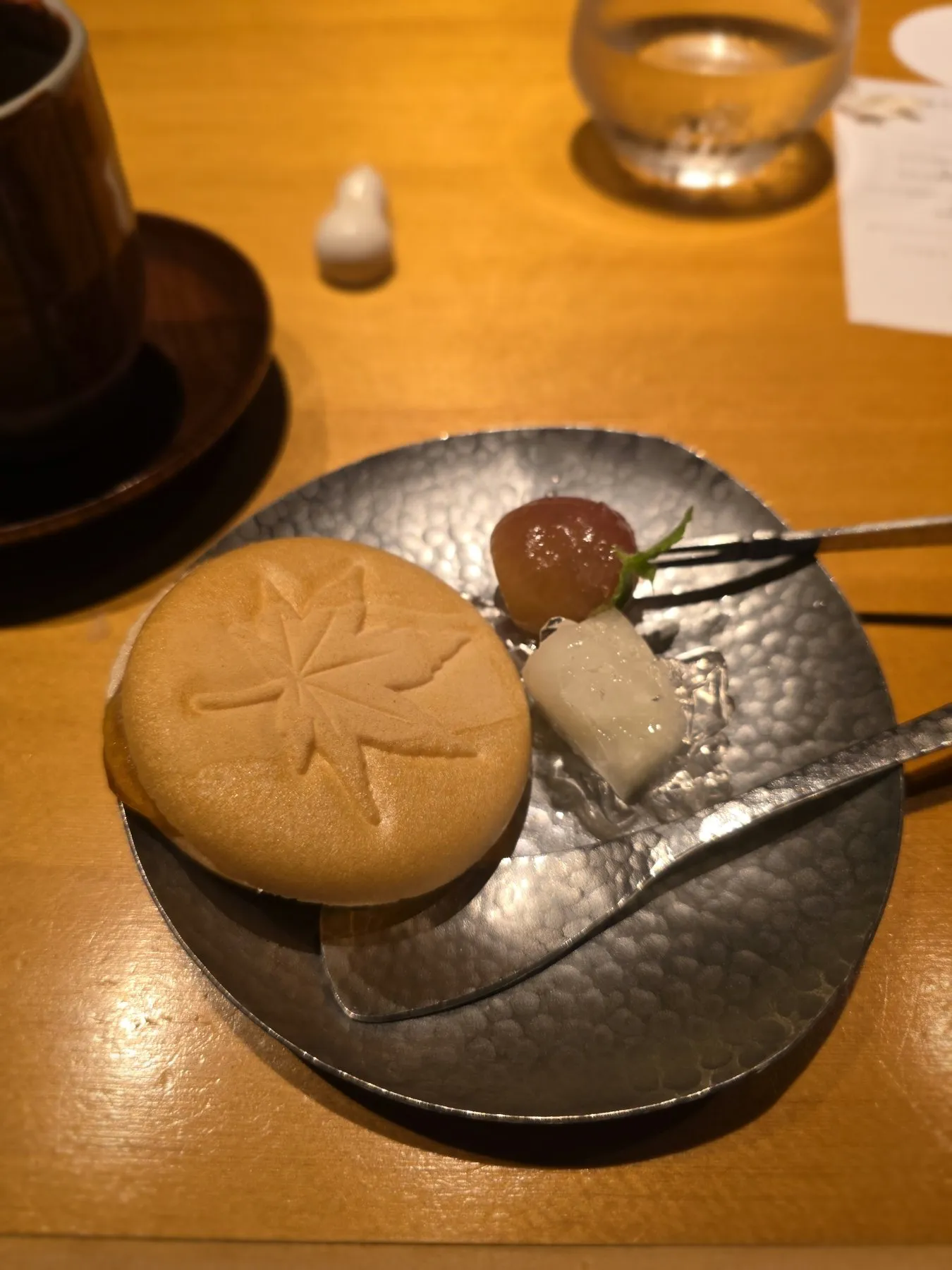 Maple leaf shaped manju on a metal plate