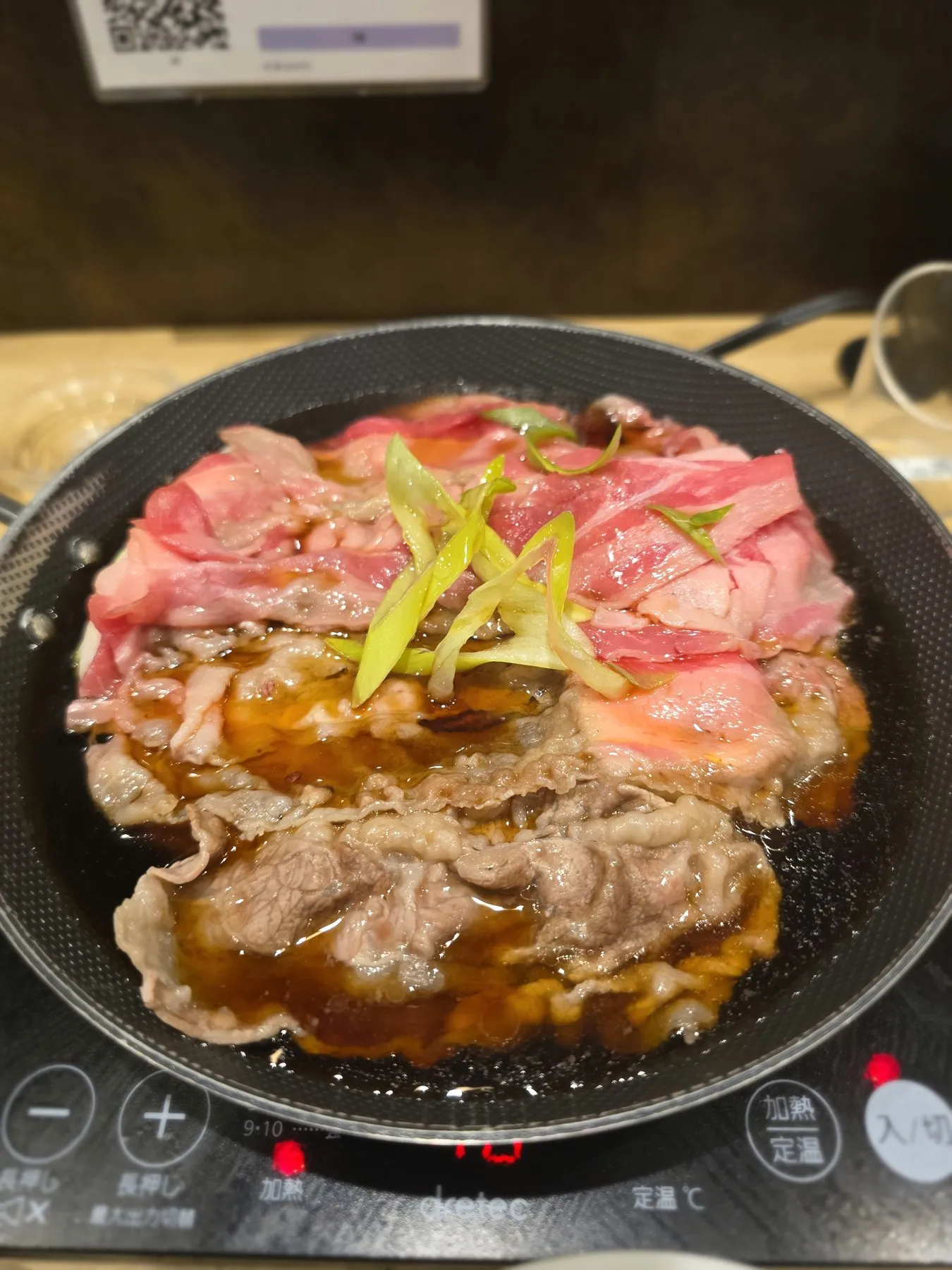 Sukiyaki beef cooking in a pan