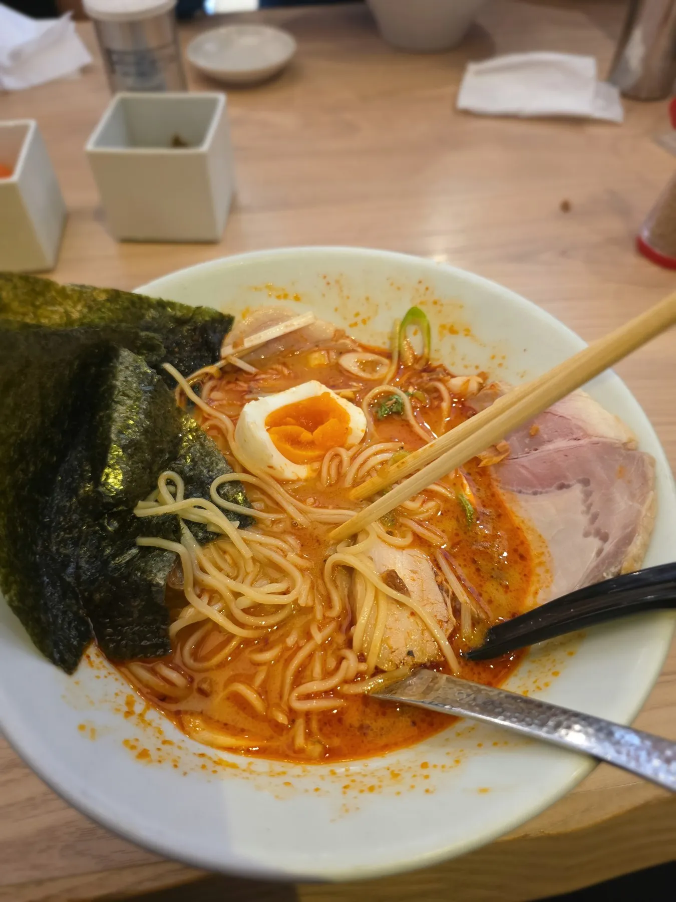 Bowl of spicy ramen with egg and nori