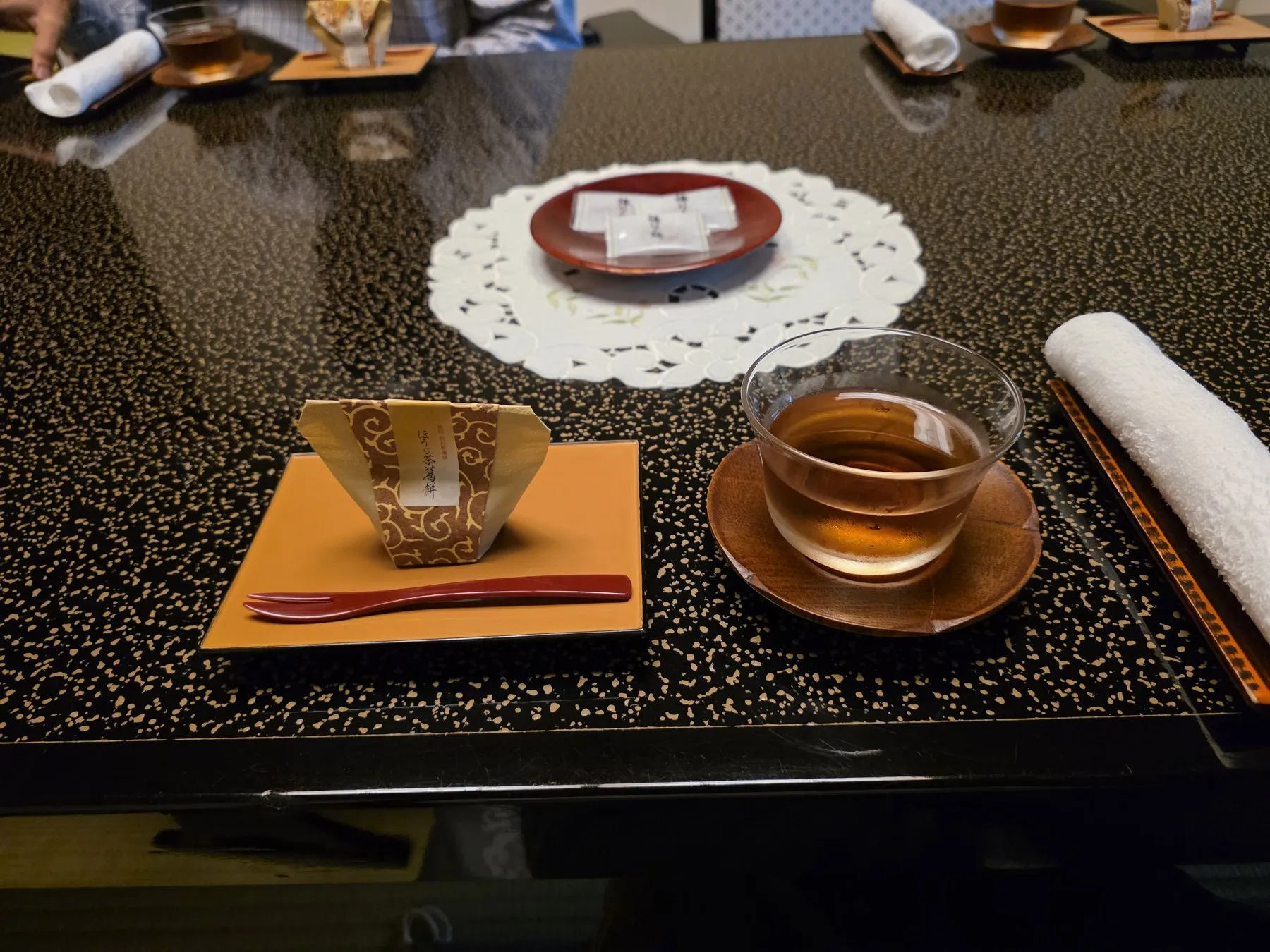Cold tea and a sweet on a lacquer table